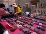 A Chinese trader with her display of silk ties at the Loule market - Algarve