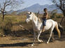 Boy riding white horse bareback with Volc
