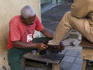 Shoeshiner at work on street.