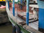 Dog standing watch on boat in harbour.