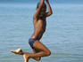 Boy swinging from rope over sea, Little Corn Island.
