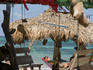 Man relaxing in hammock at Miss Grace's Cool Place cabins and restaurant, Little Corn Island.