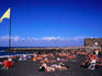 People sunbaking on beach at Playa Jardin.