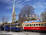 Trams in front of Cathedral Church of Christ, Cathedral Square.