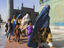 Women in burqas and child pilgrims at the Shrine of Hazrat Ali.