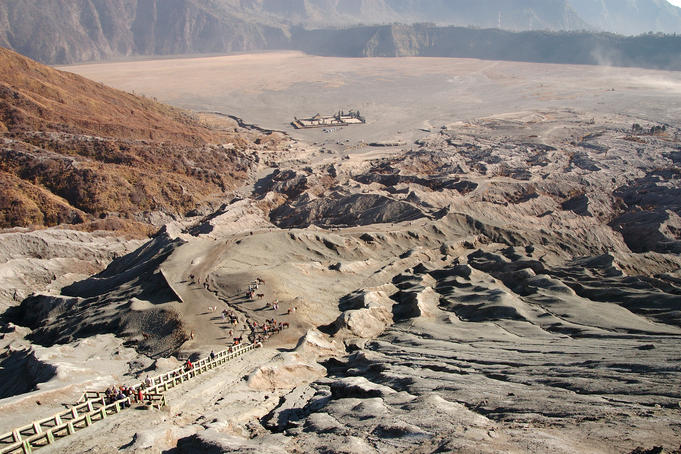 Stairs leading to Gunung Bromo's crater, with carpark, Hindu temple and Sand Sea beyond.