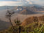 Three craters of Bromo (fuming), Batok and Kursi within huge caldera surrounded by Sand Sea, with Gunug Semeru in background.