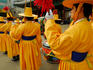 Men in yellow costumes parading.