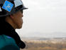 South Korean ROK soldier in Joint Security Area looking to the North across DMZ.