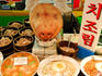 Pig's head amongst dishes for sale at Namdaemun Market.