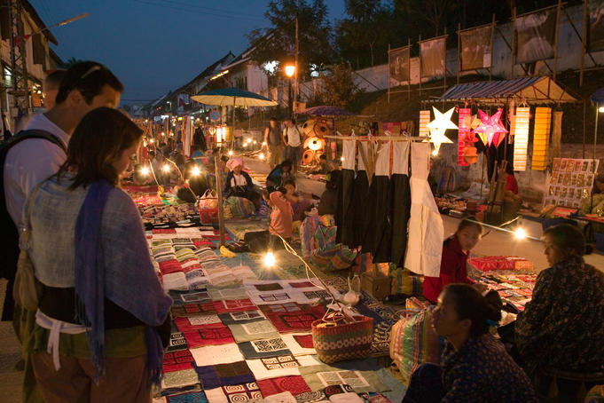 Customers at stall at night market.