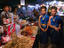 Young dancers at food stalls.