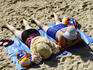 Two women sunbathing on Cronulla beach.