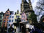 Children playing with water in a fountain in the old town (Altstadt) with heritage buildings and the Romanesque Church of Gross Saint Martin in the background.