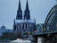 Cologne Cathedral (Kolner Dom) overlooks the Rhine River and Hohenzollern Bridge.