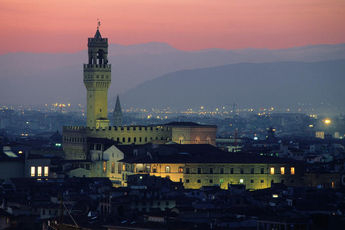 City skyline, with Palazzo Vecchio, illuminated at dusk.