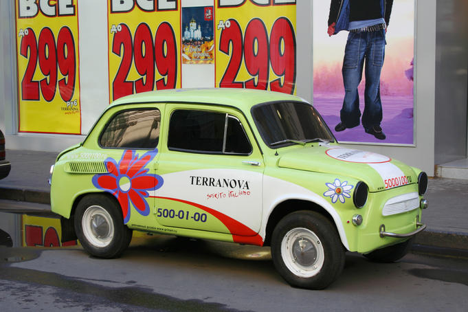 Soviet era motor car advertising a clothing store.