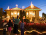 Family enjoy Christmas Light of suburban house.