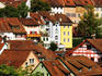 Gothic Stadtturm (tower, also known as Brugger- or Baderturm) above old houses in medieval town centre.