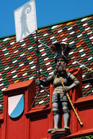 Detail of vivid red Rathaus (town hall) facade, with statue carrying Basel's coat of arms and rival Z
