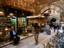 Man carrying large basket of bread through Bazaar of Khan al-Khalili, market area.