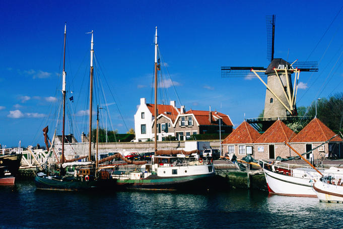 Harbour with windmill in background.