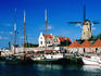 Harbour with windmill in background.