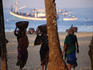 Beach labourers haul baskets of fresh marine produce, Colva