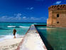 Tourist near moat wall of Fort Jefferson, Garden Key