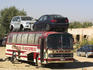 Broken down bus transporting two cars on the roof from Kabul to Ghazni.