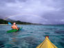 Sea kayaking with rainbow in background, Rarotongan Beach resort.