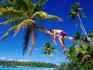 Man relaxing on coconut tree.