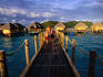 Children walking over bridge near over water bungalows, Bora Bora Pearl beach resort.