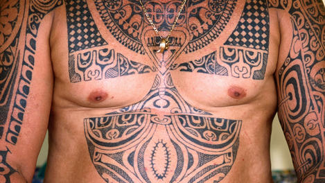 Man illustrated with Polynesian tattoos.