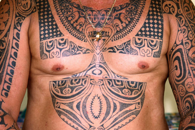 Man illustrated with Polynesian tattoos