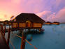 Over water bungalows at sunset, Tahaa Pearl beach resort.