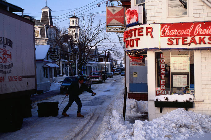 Walking across a snow filled street to the Lobster Pot Restaurant - Provincetown, Cape Cod, Massachusetts