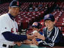 Baseball: Boston Red Sox baseball third baseman (or player) John Valentin signing an autograph on a baseball for young fans at Fenway Park Stadium - Boston, Massachusetts