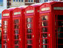 Row of traditional red telephone boxes.