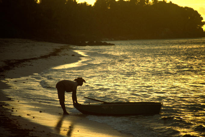 Man going fishing at dawn, Anse Royale.