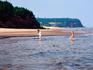 Girls play in rising tide, Red Point National Park.