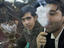 Man smoking sheesha water pipe.