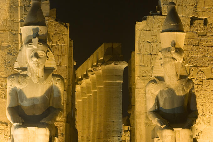 Ruins floodlit at night.
