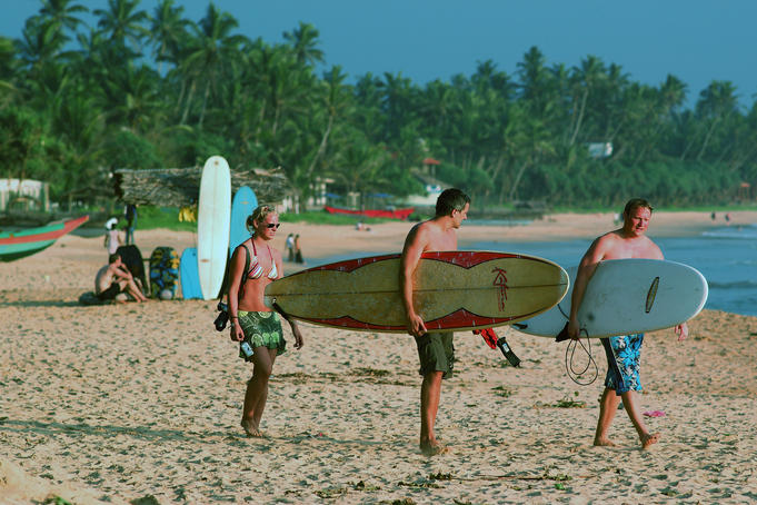 Surfers on main beach, heading out.