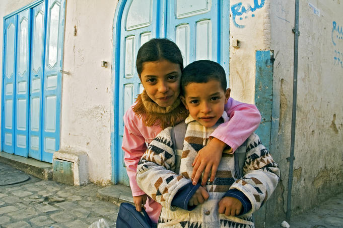 Portrait of young girl and boy on their way to school.