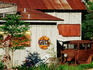Rusted building and car in Crossing historic district, Bastrop.