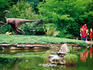 Children and adult standing near Ornithomimus dinosaur sculpture in Botanical Gardens, Zilker Park.