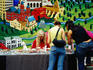 Women shopping at Renaissance Market, with mural on wall behind, Guadalupe Street.