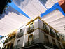 Awnings over Calle Sierpes street.