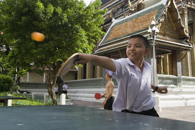 Young boys playing table tennis in Wat Ratchabopit.
